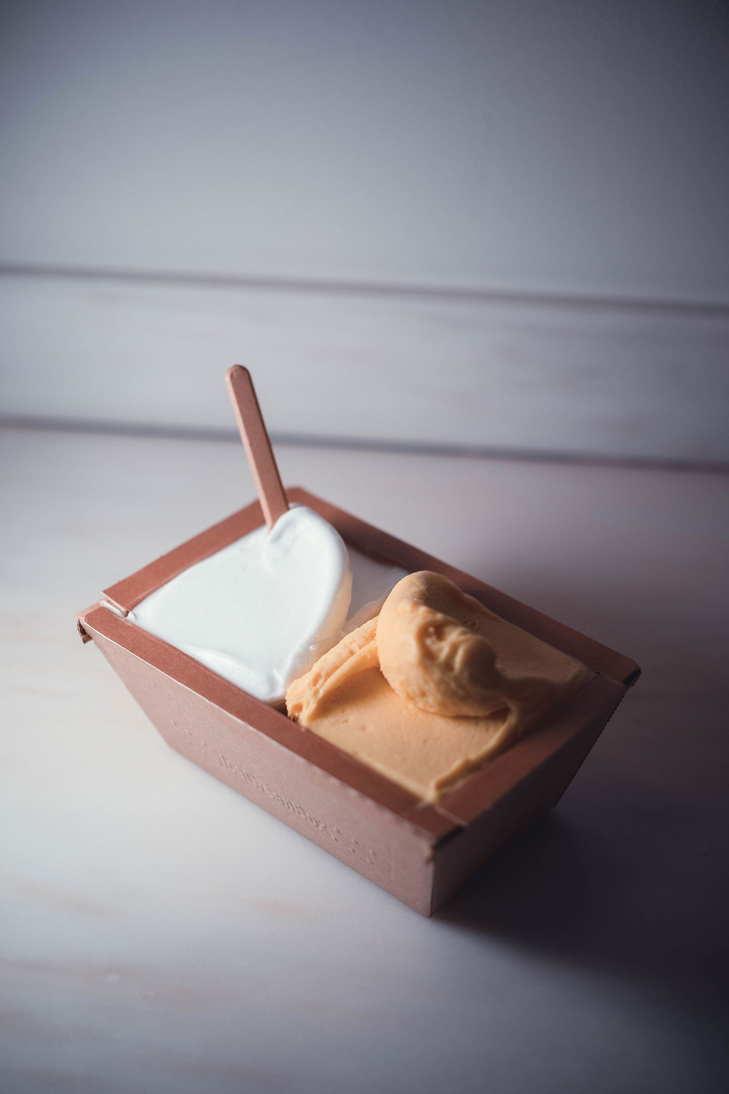 GIOLA compostable paper tub with gelato and wooden spoon