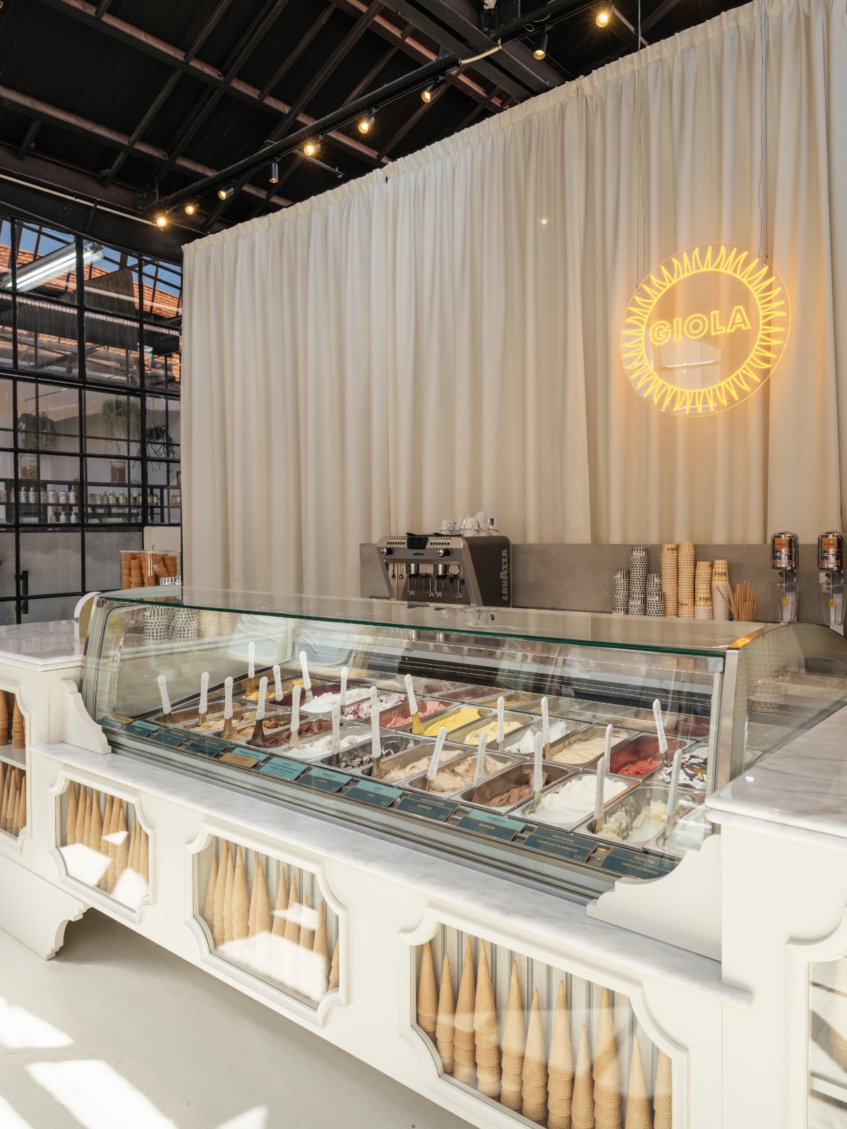 Inside Giola LX Factory — gelato counter and neon logo