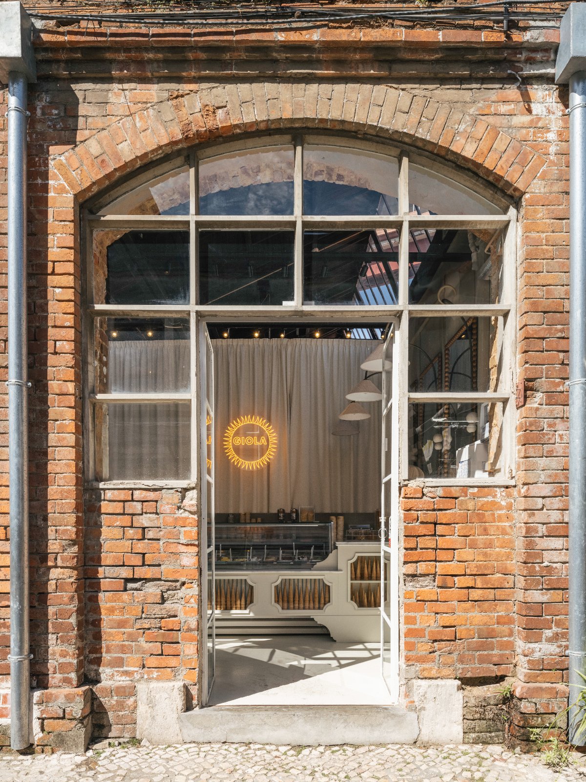Giola LX Factory brick storefront with arched windows